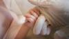 Baby holding a hand