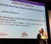 photo of ICRA Awards Chair Martin Buss presenting Best Multi-Robot Systems Paper Award to Magnus Egerstedt