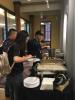 A picture of Ivan Allen College of Liberal Arts students eating food at a reception for international students. 