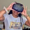 Kala Jordan, research engineer II, holding a VR/AR headset.