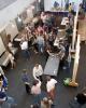 People walk around and look at student projects at a Make 10 Event at the School of ID.