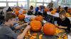Industrial design students carve pumpkins as part of a class project.