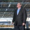 Norman “Finn” Findley, CEO of the startup Quest Renewables, stands beneath his company’s QuadPod Solar Canopy system.