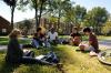 Students sit together in the grass on campus