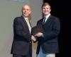 Rafael Bras presents Jonathan Tuck with the Love Family Foundation Scholarship Award.