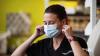 Demonstrating use of surgical mask