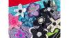 crocheted flowers are bunched together, lying on a crocheted blanket